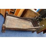 18TH/19TH CENTURY CARVED HARDWOOD CHILD'S BED ON DECORATIVE SQUARE SUPPORTS.