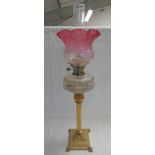 LATE 19TH CENTURY PARAFFIN LAMP WITH BRASS COLUMN CUT GLASS BOWL & CRANBERRY GLASS SHADE