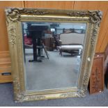 19TH CENTURY BEVELLED EDGED RECTANGULAR MIRROR WITH DECORATIVE GILT FRAME 76 CM TALL X 62 CM WIDE