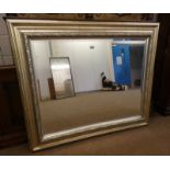 LARGE RECTANGULAR BEVELLED EDGE MIRROR WITH SILVERED FRAME.