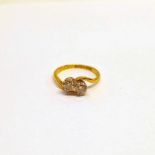 18CT GOLD DIAMOND SET 2 - STONE TWIST RING, THE 2 DIAMONDS APPROX 0.