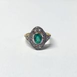 EARLY 20TH CENTURY 18CT GOLD EMERALD & DIAMOND RING THE OVAL FACETED EMERALD SET WITHIN AN OPENWORK