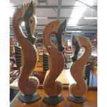 SET OF 3 CARVED WOODEN SEA HORSES.