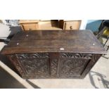 19TH CENTURY OAK COFFER WITH LIFT TOP & DECORATIVE CARVED PANEL.