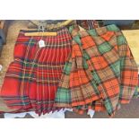 2 TARTAN KILTS Condition Report: Dark red kilt has old repairs and patches.