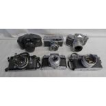 SIX 35 MM SLR CAMERAS INCLDUING NIKKORMAT WITH 1:2 50 MM LENS, PETRI 7S WITH 1:8 45 MM LENS,