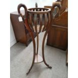 MAHOGANY POT STAND WITH CARVED SWAN DECORATION ON SHAPED SUPPORTS.