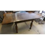 EARLY 20TH CENTURY OAK DRAW LEAF DINING TABLE ON BALUSTER SUPPORTS LABELLED LEBUS FURNITURE,