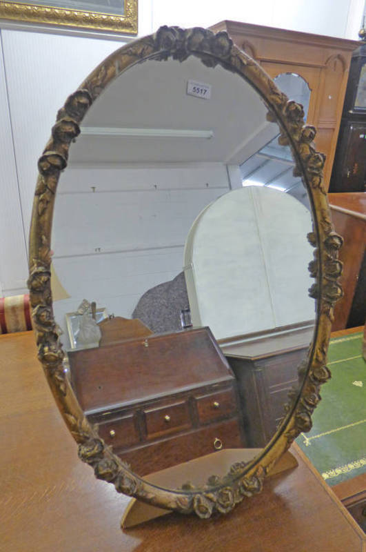 OVAL GILT MIRROR WITH DECORATIVE FRAME ON STAND