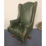 20TH CENTURY GREEN LEATHER OVERSTUFFED WINGBACK SWIVEL CHAIR ON 5 SPREADING OAK SUPPORTS.