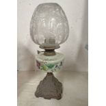 PARAFFIN LAMP WITH COLOURED GLASS RESERVOIR DECORATED WITH FLOWERS WITH ITS ETCHED GLASS SHADE ON