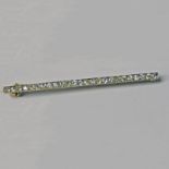 LATE 19TH OR EARLY 20TH CENTURY DIAMOND SET BAR BROOCH IN AN ENGRAVED SETTING APPROX. 1.