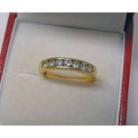 18CT GOLD DIAMOND SET 7 - STONE RING, APPROX 0.