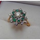 EMERALD AND DIAMOND SET CLUSTER RING MARKED 18CT THE CENTRALLY SET DIAMOND OF APPROX. 0.
