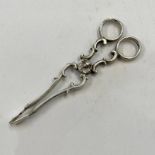 PAIR OF 19TH CENTURY DANISH SILVER SUGAR NIPS WITH CHERUB DECORATED CENTRE PIN