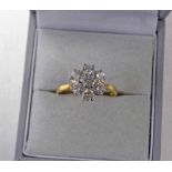 18 CT GOLD DIAMOND SET CLUSTER RING. THE 7 BRILLIANT CUT DIAMONDS OF APPROX 1.