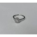 PLATINUM SET DIAMOND CLUSTER RING, THE OVAL CENTRAL DIAMOND VERY APPROX 0.