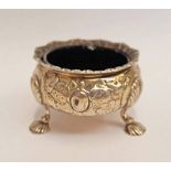 GEORGE III SILVER CIRCULAR SALT WITH EMBOSSED DECORATION ON PAD FEET WITH BLUE GLASS LINER,