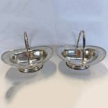 PAIR OF SILVER OVAL SWING HANDLED PEDESTAL BASKETS BY AITKIN BROTHERS, SHEFFIELD 1901 - 16 CM LONG,