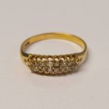 18CT GOLD DIAMOND SET RING IN A SCROLL SETTING