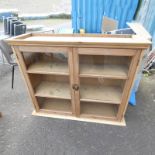 PINE BOOKCASE WITH 2 GLAZED PANEL DOORS OPENING TO SHELVED INTERIOR,