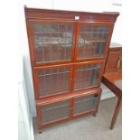 MAHOGANY BOOKCASE WITH SHELVED INTERIOR BEHIND 4 LEADED GLASS PANEL DOORS OVER BASE WITH 2 LEADED