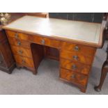 19TH CENTURY MAHOGANY KNEEHOLE DESK WITH 9 DRAWERS & PANEL DOOR ON BRACKET SUPPORTS.