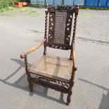 LATE 19TH CENTURY CARVED OAK FRAMED OPEN ARMCHAIR WITH BERGERE PANEL BACK & SEAT ON BARLEY TWIST