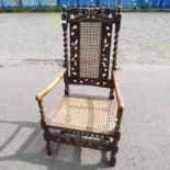 LATE 19TH CENTURY CARVED OAK FRAMED OPEN ARMCHAIR WITH BERGERE PANEL BACK & SEAT ON BARLEY TWIST