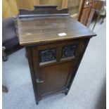EARLY 20TH CENTURY WALNUT BEDSIDE CABINET WITH CARVED PANELS