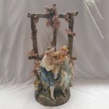 CERAMIC STATUE OF A COUPLE SITTING ON A WATER WELL WITH FLORAL DECORATION - 62 CM