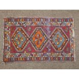 PERSIAN RUG WITH RED, BLACK, ORANGE DECORATIONS 76 CM X 48.