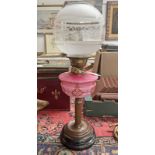 PARAFFIN LAMP WITH PINK GLASS RESEVOIR AND ETCHED GLOBULAR SHADE ON CORINTHIAN COLUMN