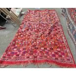 LARGE RED GROUND MULTI COLOUR AND MULTI PATTERNED CARPET,