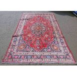 RED GROUND PERSIAN MARSHAD CARPET WITH CENTRAL MEDALLION FLORAL PATTERN - 310 X 205CM