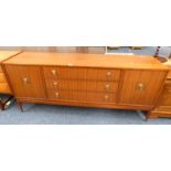 20TH CENTURY TEAK SIDEBOARD WITH 3 CENTRALLY SET DRAWERS FLANKED EACH SIDE BY 2 PANEL DOORS