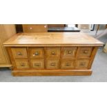 HARDWOOD RECTANGULAR COFFEE TABLE WITH INSET TOP & 10 DOUBLE ENDED DRAWERS TO SIDE,