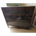ARTS & CRAFTS STYLE OAK SECTIONAL BOOKCASE WITH 3 GLAZED PANEL DOORS ON BARLEY TWIST SUPPORTS.