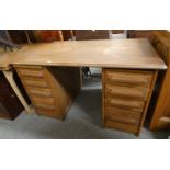20TH CENTURY OAK TWIN PEDESTAL DESK WITH 2 STACKS OF 4 GRADUATED DRAWERS.
