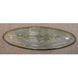 OVAL GLASS PANEL WITH METAL DECORATION.