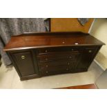 STAG SIDEBOARD WITH 4 CENTRALLY SET DRAWERS FLANKED EACH SIDE BY 2 PANEL DOORS,