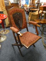 EARLY 20TH CENTURY MAHOGANY FOLDING ARMCHAIR WITH DECORATIVE CUSHIONED BACK & SEAT