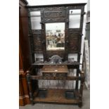 CARVED OAK MIRROR BACK HALLSTAND WITH SINGLE DRAWER WITH DECORATIVE MASK HANDLE,