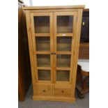 21ST CENTURY OAK DISPLAY CABINET WITH 2 GLAZED PANEL DOORS OPENING TO SHELVED INTERIOR OVER 2