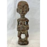 AFRICAN FERTILITY FIGURE, CARVED WOODEN FORM WITH HANDS TO STOMACH,