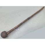 TRIBAL CARVED WOOD CLUB / KNOBKERRIE WITH INCISED GLOBULAR HEAD ON A WOODEN 64CM LONG SHAFT WITH