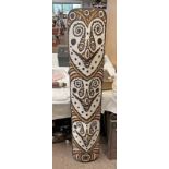 TRIBAL CARVED WOOD SPIRIT BOARD WITH CARVED FRONT DECORATED WITH WHITE, BROWN AND PINK PIGMENTS,