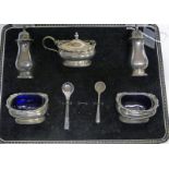 CASED 5 PIECE SILVER CRUET SET WITH BLUE GLASS LINERS,