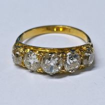 DIAMOND SET 5 STONE RING WITH A YELLOW METAL SCROLL SETTING, THE CUSHION SHAPED DIAMONDS APPROX 2.