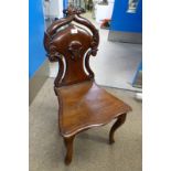 19TH CENTURY MAHOGANY HALL CHAIR WITH DECORATIVE CARVED BACK ON CABRIOLE SUPPORTS.